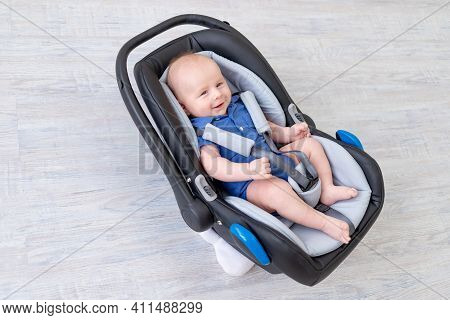 Baby Boy In Car Seat, Happy Newborn Lying Strapped In Seatbelt