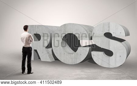 Rear view of a businessman standing in front of RCS abbreviation, modern technology concept