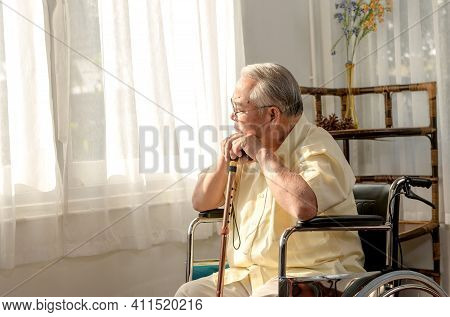 Lonely Asian Senior Man Was Sick And Sitting On Wheelchair. Retirement Age Lifestyle And Stay At Hom