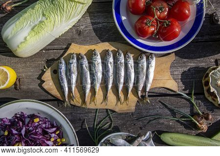 Vegetarian Lunch. Red Cabbage Salad, Chinese Cabbage, Tomatoes And Lightly Salted Fish - Sardine And