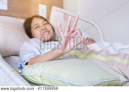 Patient Asian Woman Showing Hands Ok Sign On Sick Bed At The Hospital,health Insurance Concept
