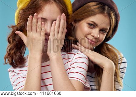 Girl In A Yellow Beret And A Woman On A Blue Background Mom And Daughter