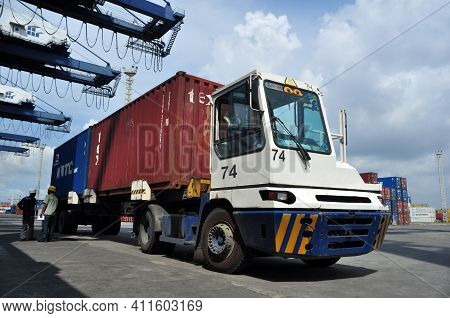 Jakarta, Indonesia - May 6, 2017: Container Trucks Passed Between Stacks Of Containers At The Port O