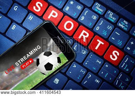 Sports Live Streaming Concept Showing Soccer Or Football Game Broadcast On Smartphone With Laptop Hi