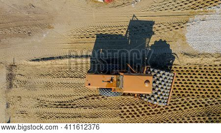 Above Top View, Overhead On Huge Road Roller With Spikes Is Compacting Soil, Sand At Building Site F