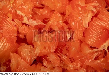 Red Honey Pomelo Peeled And Disassembled Into Slices. Close-up Selective Focus.