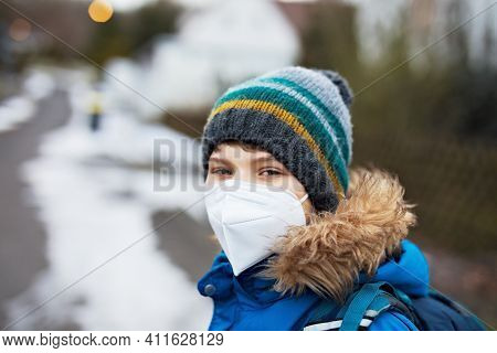 Kid Boy Wearing Ffp Medical Mask On The Way To School. Child Backpack Satchel. Schoolkid On Cold Aut