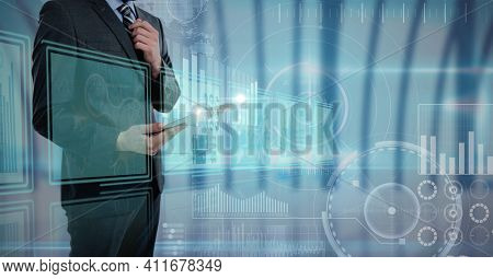 Digital interface with data processing against mid section of businessman using digital tablet. computer interface and business concept