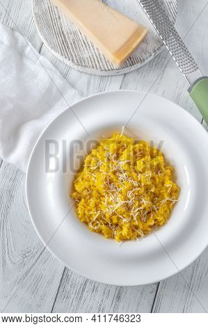 Portion Of Saffron Risotto On The Wooden Table