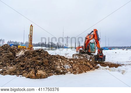Construction Equipment: Excavator, Drilling Rig, Construction Site In Winter. Engineering Surveys An