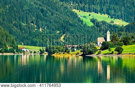 Church In Reschen Am See Or Resia, A Village On Lake Reschen In South Tyrol, Italian Alps