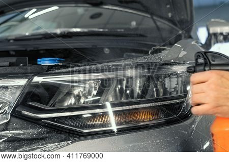 Ppf Installation On Car Headlight. Paint Protection Film Is Protective Polyurethane Coating For Pain