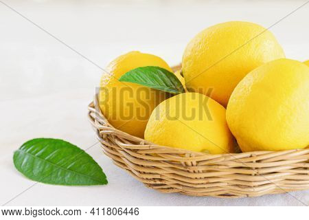 Group Of Whole Organic Lemon In Wood Basket On White Background. Fresh Lemon Have High Vitamin C And
