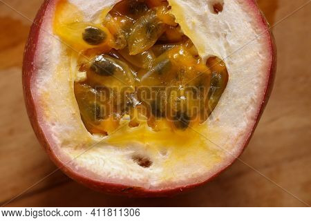 Half Cut Passion Fruit On Wooden Background. Fresh Passion Fruits-healthy Fruit And Special Taste
