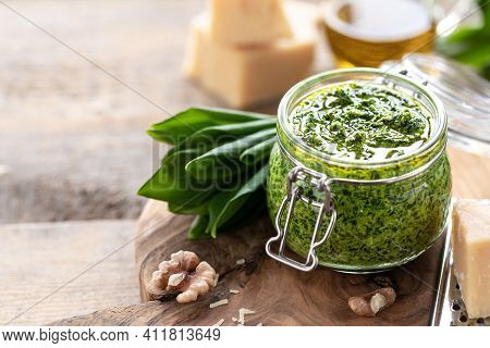 Wild Leek Pesto With Olive Oil And Parmesan Cheese In A Glass Jar On A Wooden Table. Useful Properti
