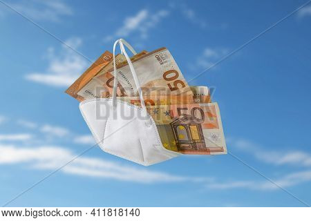 Medical Ffp2 Face Mask Against Covid-19 Filled Like A Bag With Euro Banknotes, Concept For Enrichmen