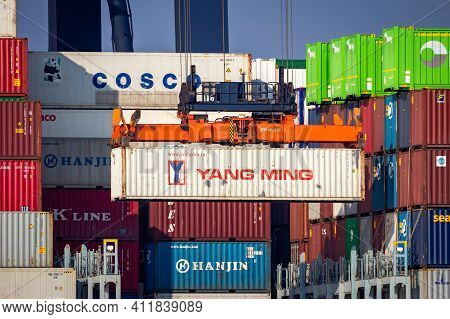 Crane Operator Unloading A Sea Container From A Cargo Ship The Port Of Rotterdam. March 3, 2016