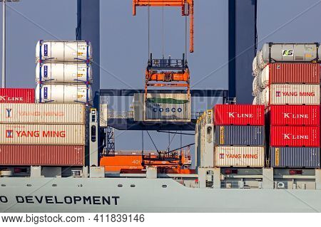 Crane Operator Unloading A Sea Container From A Cargo Ship The Port Of Rotterdam. March 3, 2016
