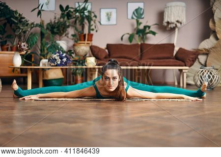 Young Sporty Woman Practicing Yoga At Home Doing Stretching Exercise The Center Split Pose, Straight