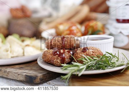 Close-up Of Fried Chicken Kievs, Poultry Cutlets On A White Plate, On A Wood Cutting Board. De Volai