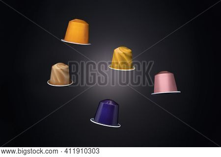 Five Flying Colorful Espresso Coffee Capsules On Black Background
