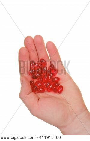 Krill Oil Capsules. Red Gelatin Capsules With Krill Oil In Hand Isolated On White Background.source 