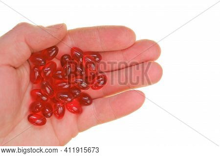 Krill Oil Capsules. Red Capsules With Krill Oil In Hand Isolated On White Background.source Of Omega