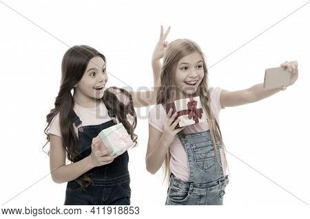 Posing As Models. Small Fashion Models Taking Selfie On Smartphone. Little Photo Models With Gifts C