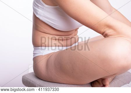 Plus Size Woman Model with Natural Real Body in cotton underwear showing extra pounds on the stomach, imperfect nonideal body part