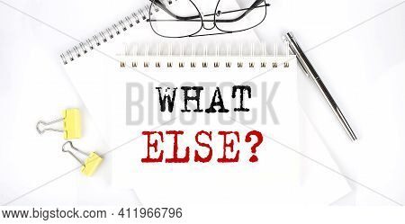 What Else Text On Notebook With Pen,clips And Glasses