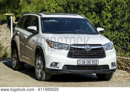 Subaru's Car Is White In The Afternoon In The Parking Lot. Sunny Autumn Day. Front View. Crimea, Sud