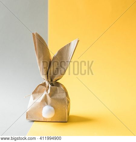 Easter Bunny Paper Gift Egg Wrapping Diy Idea On Colorful Background. Minimal Easter Concept, Flat L