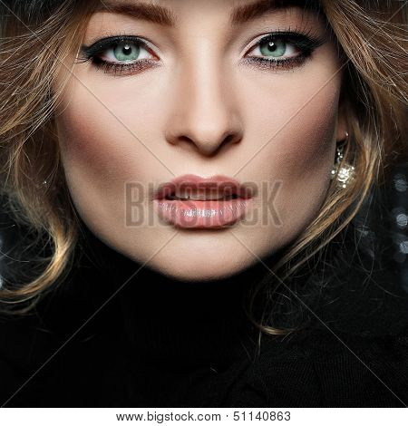 Portrait of beautiful sexual blonde in a fur cap 