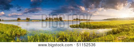 Beautiful view of sinuous river in summer. Dramatic overcast sky. Southern Buh River, Ukraine, Europe. Beauty world.