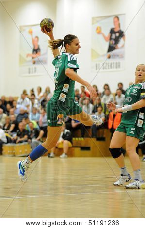 SIOFOK, HUNGARY - SEPTEMBER 14: Katarina Bulatovic (with ball) in action at a Hungarian Championship handball match Siofok KC (black) vs. Gyori ETO KC (green), September 14, 2013 in Siofok, Hungary.