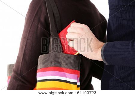 Pickpocket are stealing wallet from bag, close up, isolated on white