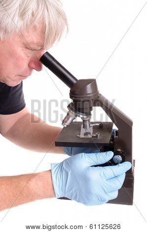 researcher looking through an old microscope isolated on white