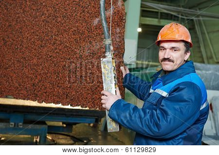 industrial worker at factory on granite or marble manufactur?