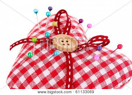 Colored pinheads in pin-cushion isolated on white