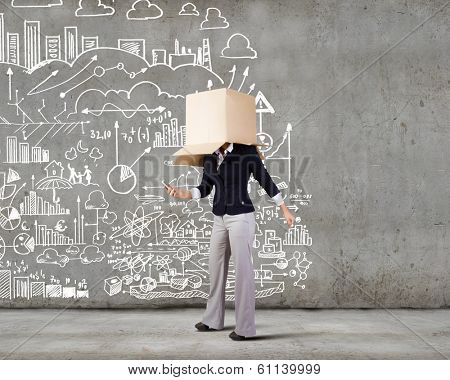 Businesswoman using mobile phone wearing carton box on head