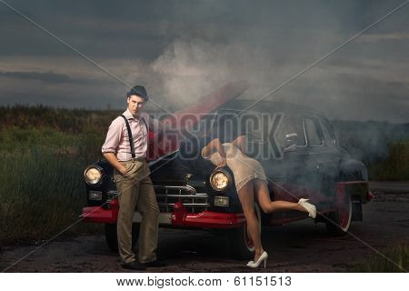 Young couple  next retro car  in smoke