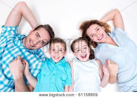 High Angle Portrait Of Caucasian Happy Smiling Young Family