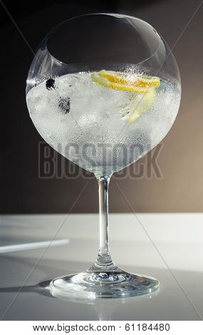 Gin tonic cocktail over a club bar background
