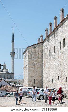 SAFRANBOLU, TURKEY - JUNE 24, 2012: Tourists under the wall of Cinci Han. This old caravanserai is operable today