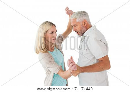 Angry man overpowering his partner on white background