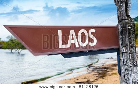 Laos wooden sign with a lake background