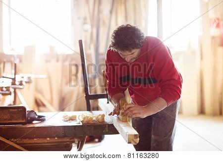 Carpenter working with plane