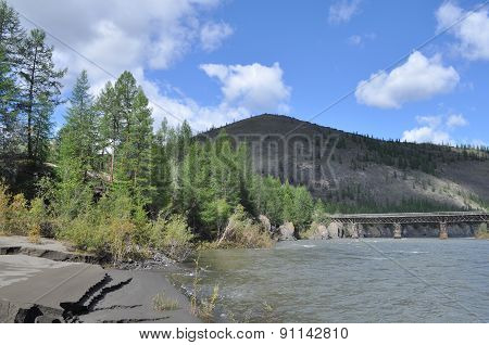 Bridge Over The Mountain River In Yakutia.