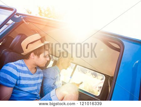 Teenage boys sitting inside an old campervan, summer roadtrip