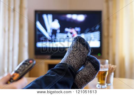 Television, Tv Watching (boxing Match) With Feet On Table Eating Snacks And Drinking Beer - Stock Ph